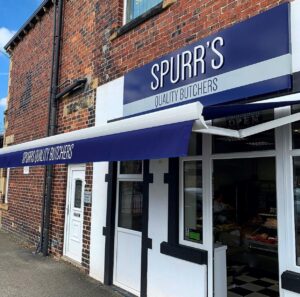 Awning with branding for a retail storefront